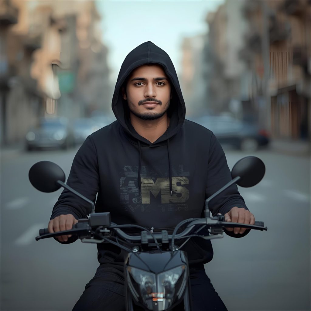 Young man in black hoodie riding motorcycle on urban street background